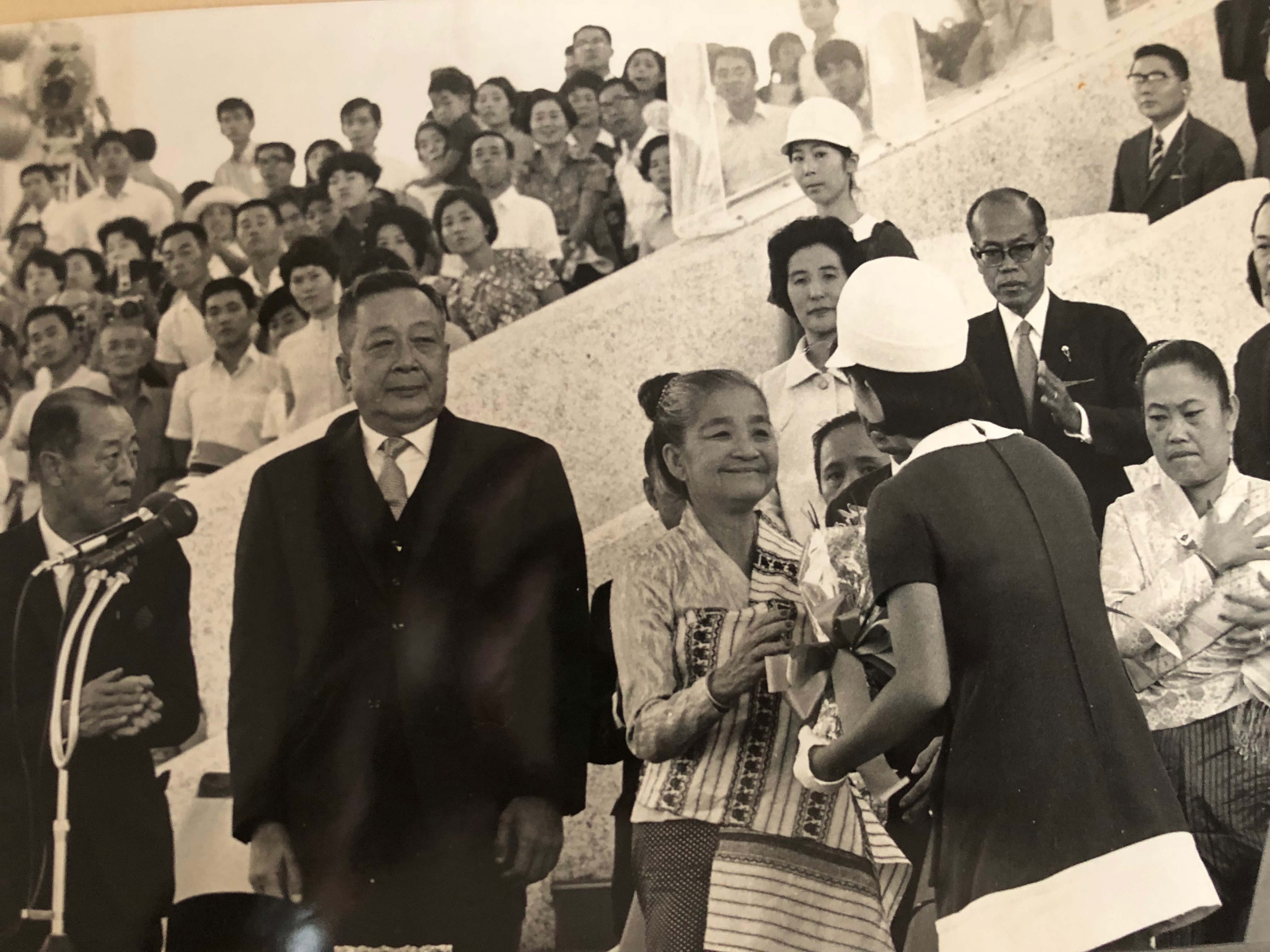 King Savang Vatthana and Queen Khamphouy accepting a gift during the Laos National Day ceremony